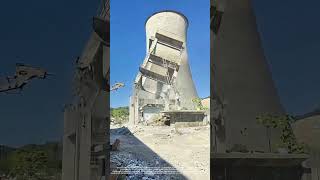 demolishing the abandoned steel-concrete building structures near the water tower and chimney