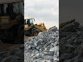 sdlg matadors wheel loader pushing sand for backfill on construction development area.