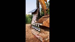 Guy picks up five bottles with excavator