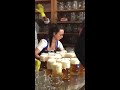 waitress carries multiple heavy beer filled mugs together