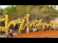 Excavators And Dozer Working Cutting Limestone Hill On New Road Construction