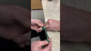Ring removal using elastic band from non-rebreather oxygen mask.