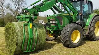 Murray Bros round bale, load, wrap and stack 1st cut