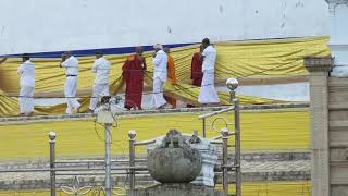 Draping Sacred Cloth Around Buddhist Stupa