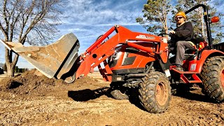 Spreading frozen aggregates with Kioti CX2510 Tractor FEL