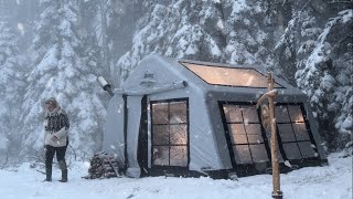 HOT TENT CAMP WITH A STOVE IN HEAVY SNOW