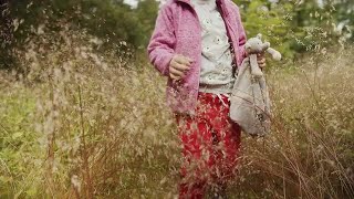 Girl Walks Through Grass Stock Video