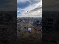 palestinians in gaza receive a hair cut in the ruins of a building