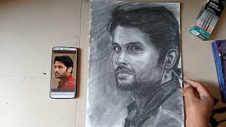 Nithin learns to make actor's portrait with willow charcoal.