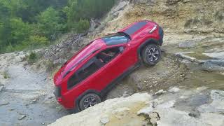 Stock Jeep Cherokee Trailhawk climbs waterfall