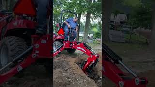 Massey Ferguson compact tractor  backhoe digging