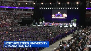Several Northwestern graduates walk out of United Center during commencement