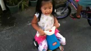 Keila on her small tricycle