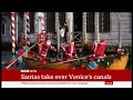 father christmas santa claus venice canal regatta goes ahead fun story italy 22 dec 2024