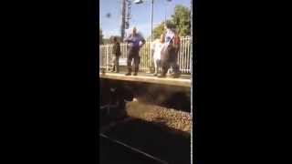 Woman jumps on track and holds up trains at Fassifern station.