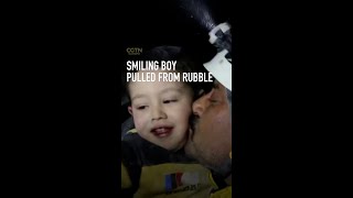 Smiling boy pulled from rubble