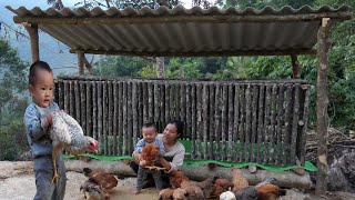 Single mother and baby processing dried fish - building new chicken coop