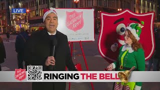 Albert Ramon and Tina Evans ringing the bell for the Salvation Army