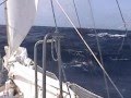 Sailing in the storm in a small wooden boat