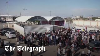 Palestinians wait at Egypt's border with Gaza, Rafah after Blinken said it will open for aid