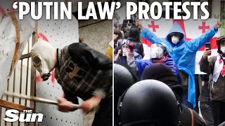 Protesters and cops clash in Georgia after nation's parliament passes hated pro-Russian law