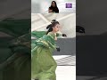 fashion show of the model skiing in a green hanfu fashion style