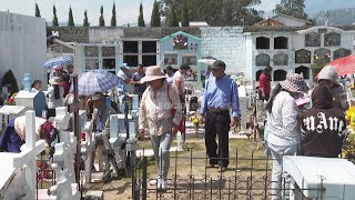 Ecuadorians mark Day of the Dead by visiting deceased loved ones in cemetery