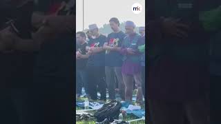 Supporters perform prayers using PN flags