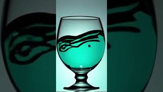 A Clear Wine Glass With Turquoise-Colored Waves Inside It