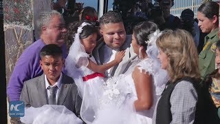 A hug and a wedding at the US Mexico border wall opening day