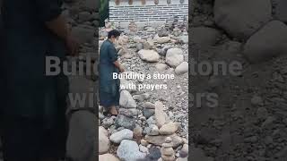 building a stone with prayers