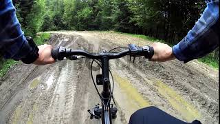 Stock footage: MTB biker cycling through muddy dirt road in Bieszczady Mountains, Poland