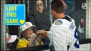Joe Pavelski gives pucks to kids along the glass