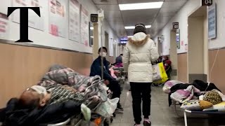 Covid patients lie in corridor beds of overwhelmed Shanghai hospital