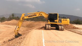 Komatsu PC210 Excavator trimming a batter អេស្កាវ៉ាទ័រធ្វើជម្រាលប្រលាយ