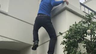 Alex Honnold climbs a building on the AFI campus