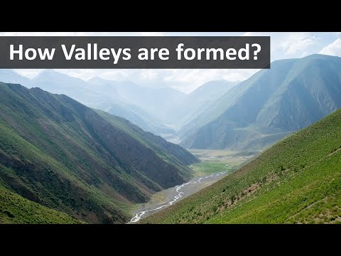 What is a stretch of low land lying between hills or mountains and usually having a river or stream flowing through it?