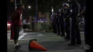 Headline: L.A. protests lead to 14 arrests; Zimmerman juror talks to Anderson Cooper