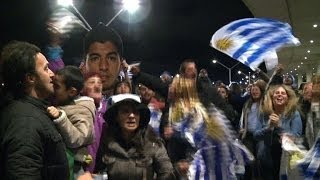 Flag-waving Uruguayans flock to airport to wait for Suarez