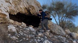 Building a warm and cozy cave with a fireplace inside Survival camp in winter