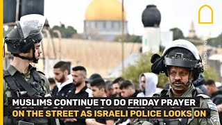 Jerusalem: Muslims pray on the street as Israeli police look on
