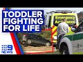 Toddler fighting for life after found unconscious in creek-bed | 9 News Australia