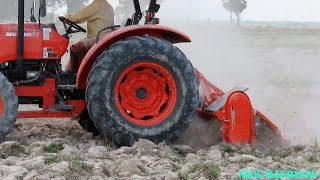 Tractor At Work - Tractor Kubota M6040SU Pulling Cultivation