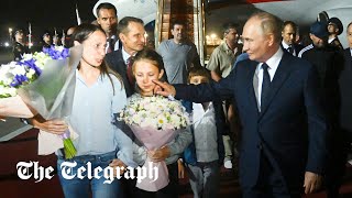 Putin wipes tear of released prisoner's child in historic exchange with US