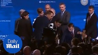 China's President grabbed by security as he almost tumbles off stage