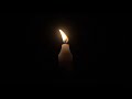 4k candle burning against black background