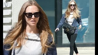 Amanda Seyfried cuts a casual figure in a navy blue zip-up hoodie and Nike kicks for a morning coffe