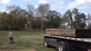 Unloading  hardwood mats with a pickup truck