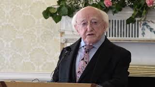 President Higgins confers the Torc, Symbol of the Office of Saoi, on Paul Muldoon