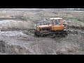 russian tractor dt 75 pushes manure on a farm